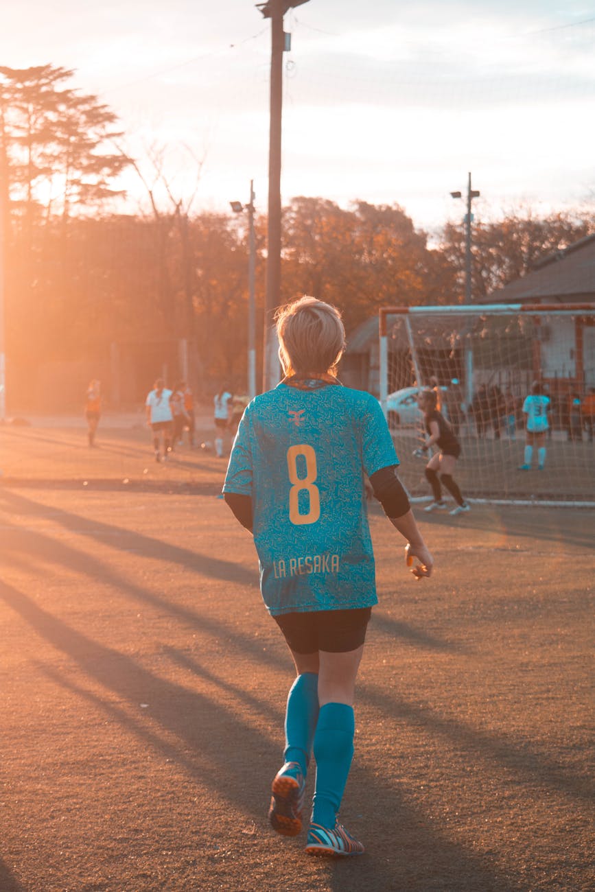 woman wearing sports attire on football field